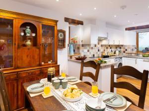 a kitchen with a wooden table with food on it at Willow Tree Barn in Kendal