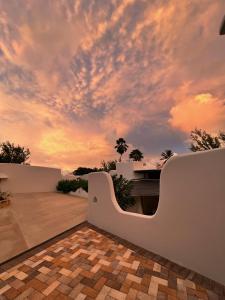 a sunset view from the patio of a villa at OceanBlue Resort in Christ Church