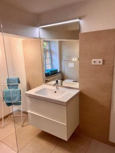 a bathroom with a sink and a mirror at Obermühle Duderstadt in Duderstadt