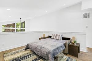 a white bedroom with a bed and a window at The Dream Catcher Home in Blue Ridge