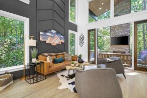 a living room with a couch and chairs and a tv at The Dream Catcher Home in Blue Ridge