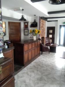 a lobby with a desk and a chair in a room at Holly Tree B&B in Bromyard