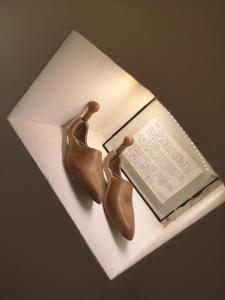 two bronze shoes sitting on top of a book at City Apartment, 2 min walk to Norwich centre. in Norwich