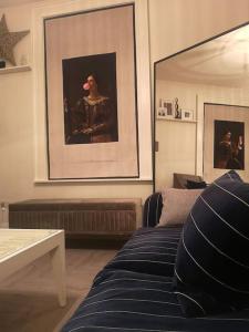 a living room with a couch and a painting on the wall at City Apartment, 2 min walk to Norwich centre. in Norwich