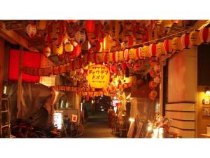 a room with a bunch of lanterns hanging from a building at Eins,Inn Umeda Higashi - Vacation STAY 30033v in Osaka