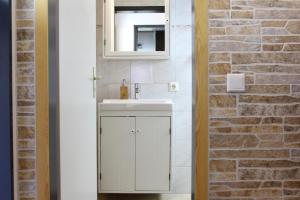 a bathroom with a white sink and a mirror at Ferienwohnung Krohn Cuxhaven in Cuxhaven