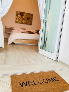 a welcome mat in a bedroom with a bed at Suite Casalbivio in Positano