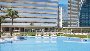 a large swimming pool in front of a building at Sunset Cliffs Luxury Apart with Sea View in Benidorm