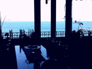 a view of the ocean from a room with chairs at Perla di Naxos in Giardini Naxos