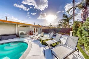 a patio with chairs and a swimming pool at The Sunny Spot Permit# 5084 in Palm Springs