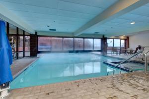 a swimming pool with blue water in a building at The Lodge at Mountain Village in Park City