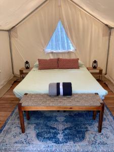 a bedroom with a bed in a tent at Tentrr Signature Site - Herb'n Soul Sanctuary in Stone Mountain