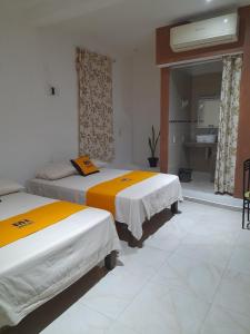 Postel nebo postele na pokoji v ubytování Mi Hotel Club