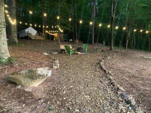 a lit up yard with a picnic table and lights at Tentrr Signature Site - Huff Farm in Maryville
