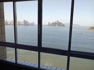 a view of the water from a window at Lar de férias in São Vicente