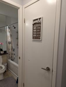 a bathroom with a chalkboard sign on the door at SkySide Downtown Condo - Free Parking in Toronto
