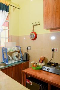 a kitchen with a sink and a counter top with a stove at Naivasha Southlake apartments in Naivasha