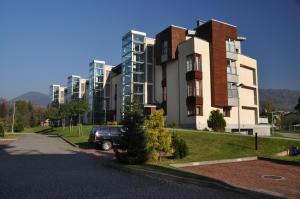 a car parked in front of a large building at Apartament Zeta Park DeLuxe in Ustroń