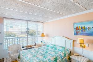 a bedroom with a bed and a large window at Shorely Suite in Atlantic Beach