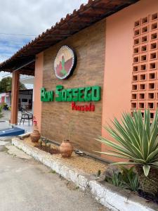 ein Restaurant mit einem Schild an der Seite eines Gebäudes in der Unterkunft Bom Sossego Pousada DG in Delmiro Gouveia