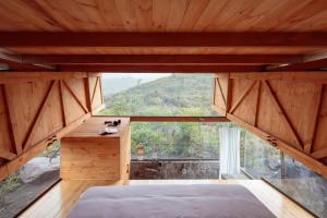 a room with a bed and a large window at Stunning cabin in Baños in Baños