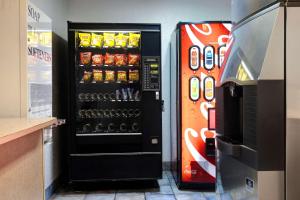 a soda vending machine in a store with a soda at Motel 6-Shepherdsville, KY Louisville South in Shepherdsville