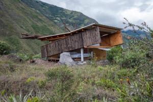 a house on top of a hill in a field at Stunning cabin in Baños in Baños