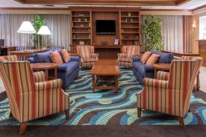 a living room with a couch and chairs and a table at Wyndham Garden Manassas in Manassas