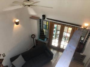 a living room with a couch and a ceiling fan at Boho hip bungalow in Old Bisbee in Bisbee