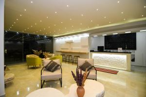 a lobby with chairs and a bar in a building at Cielo & Sal Hotel in Uyuni