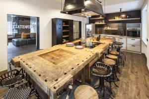 a kitchen with a large wooden table and chairs at Oberstdorf Hostel in Oberstdorf