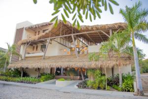 a resort on the beach with palm trees at Hotel Casa Bocana in Santa Cruz Huatulco
