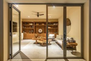 a living room with sliding glass doors at Hotel Casa Bocana in Santa Cruz Huatulco