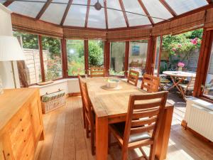 a dining room with a wooden table and chairs at Pippin Cottage in Penzance