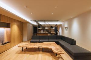 a living room with a couch and a coffee table at SEKIYA RESORT Galleria Midobaru in Beppu