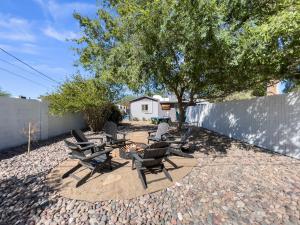 a patio with chairs and a table and a tree at Casa Del Luna in Biltmore in Phoenix