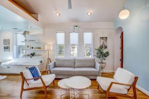 a living room with a couch and chairs and a table at Earn Your Vacation Stripes in Austin