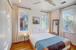 a bedroom with a large bed and two windows at Earn Your Vacation Stripes in Austin