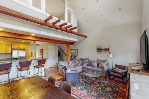a living room with a couch and a table at Saddle Ridge B2 in Big Sky