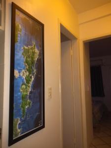 a picture of a map hanging on a wall at Apartamento em Canasvieiras in Florianópolis