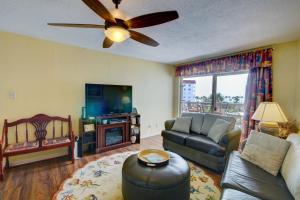 a living room with a couch and a tv at El Matador 145 - Centrally located with a view of the Gulf in Fort Walton Beach