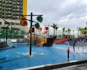 a water park with a playground with a water slide at Bali Residence Impian Raudah in Melaka