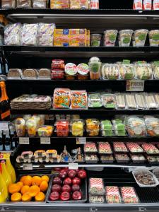 a grocery store shelf filled with different types of food at Grand Plaza Hotel in Tumon