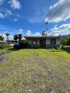 a white house with a car parked in front of it at Large & Confortable Family House in Fortuna