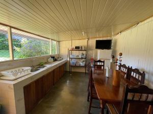 a kitchen with a wooden table and a kitchen with a sink at Large & Confortable Family House in Fortuna