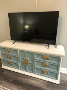 a tv on top of a dresser with blue drawers at 2 Bedrooms Vacation Home in Tampa