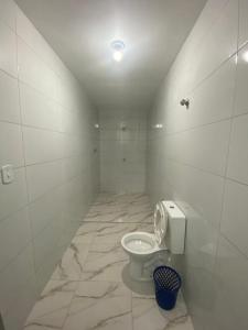 a bathroom with a toilet in a tiled room at Hotel - Motel Story in Sao Paulo