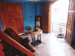 un salon avec une table et un mur bleu dans l'établissement Hotel Tihosuco Colonial, à Ekpedz