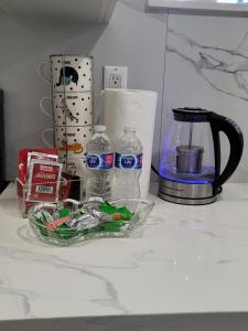 a counter top with a blender and bottles of water at Falstaff Home in Toronto