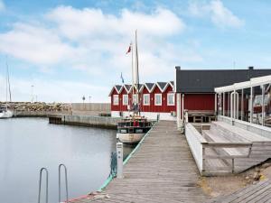 a boat is docked next to a red building at 4 person holiday home in TRÄLÖVSLÄGE-By Traum in TrÃ¤slÃ¶vslÃ¤ge